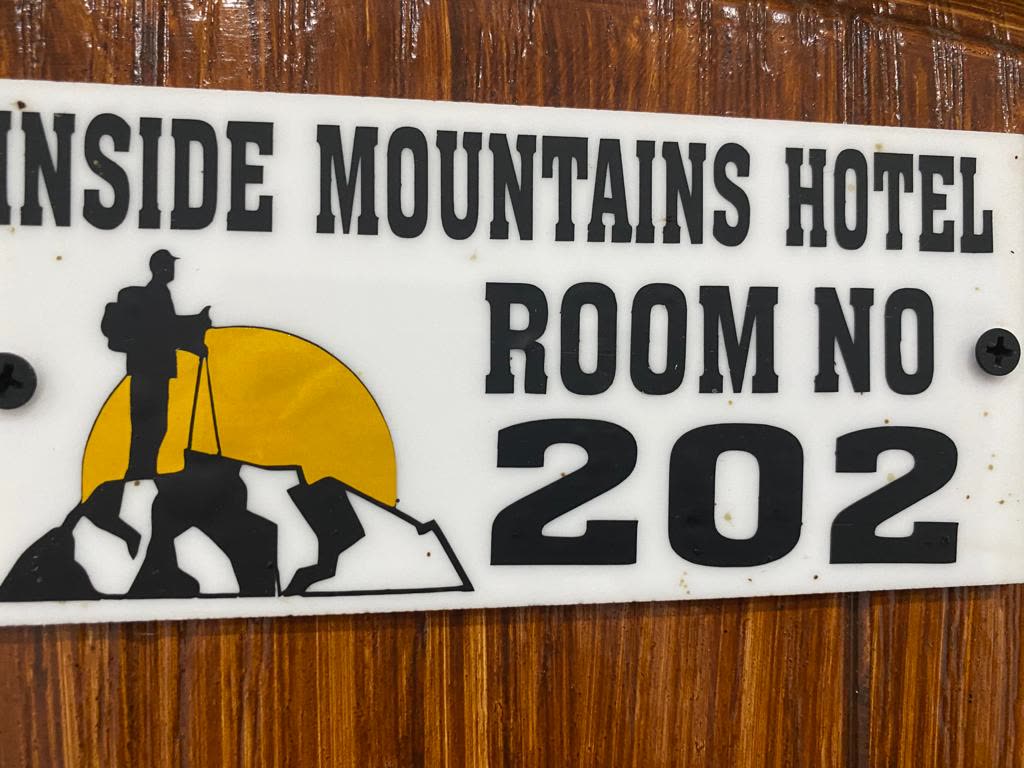 Room number plaque with the hotel's mountaineer emblem